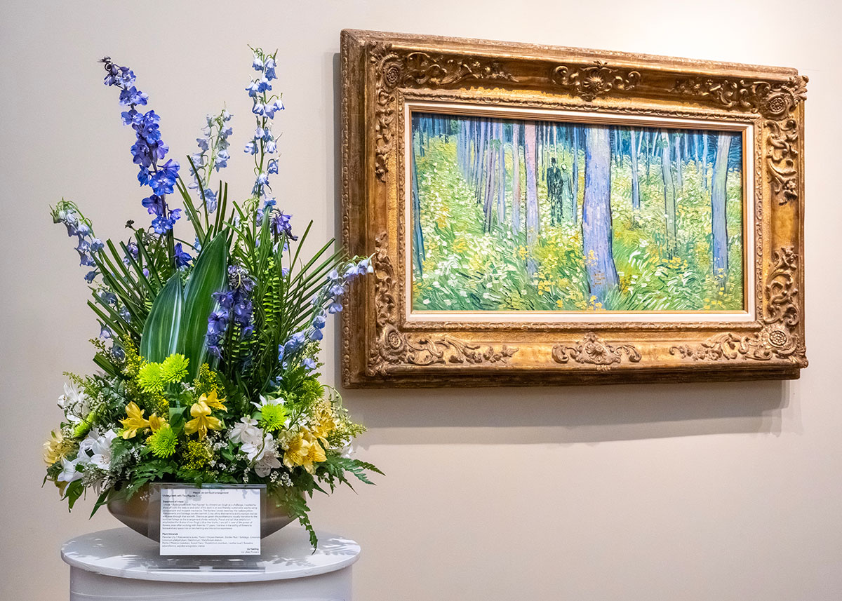 A blue, green and yellow flower arrangement beside Undergrowth with Two Figures