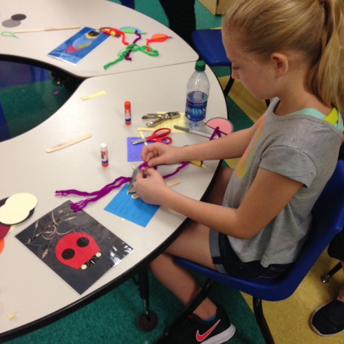 a yound girl works on arts and crafts
