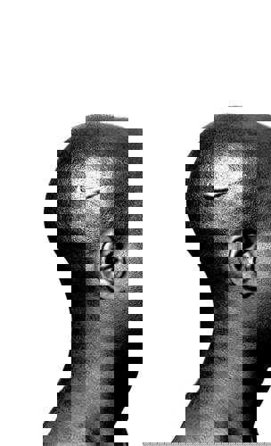 Black and white photo of the head of an African American man with the Nike swoosh logo