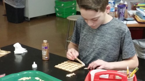 student arranging pieces