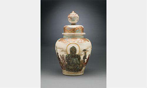A ceramic vessel with lid featuring an illustration of Buddha