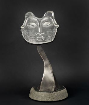 An animal face made from clear glass on a metallic base