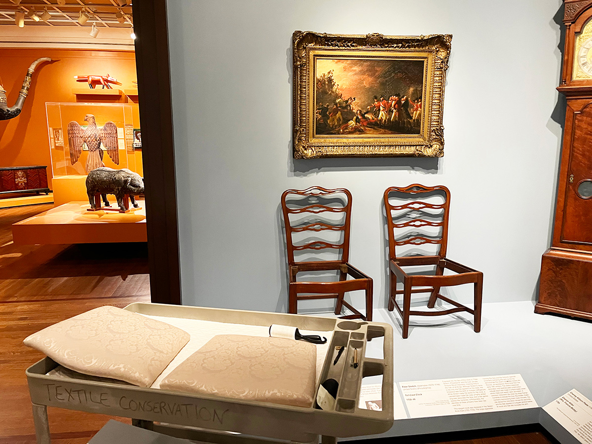 Two chairs in gallery without their seats
