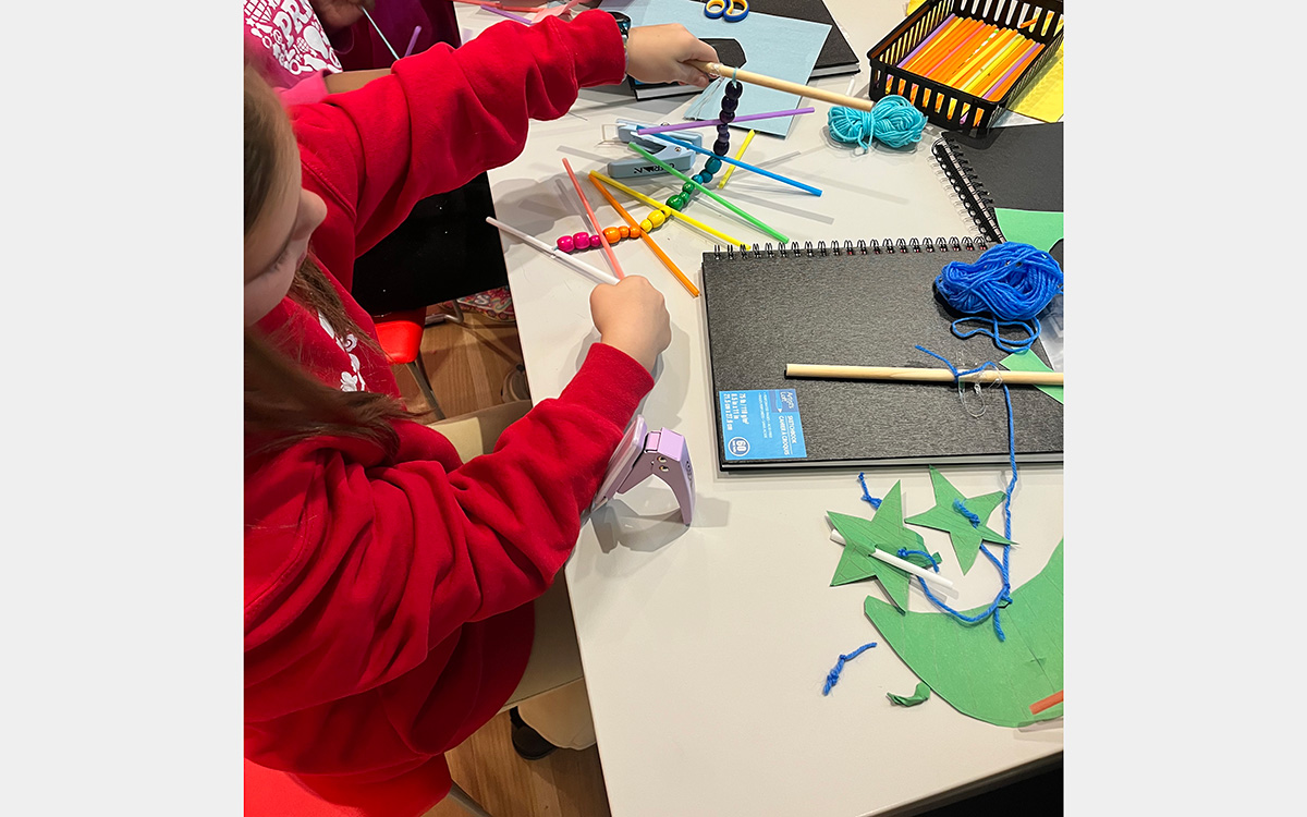 Girl making art at a table