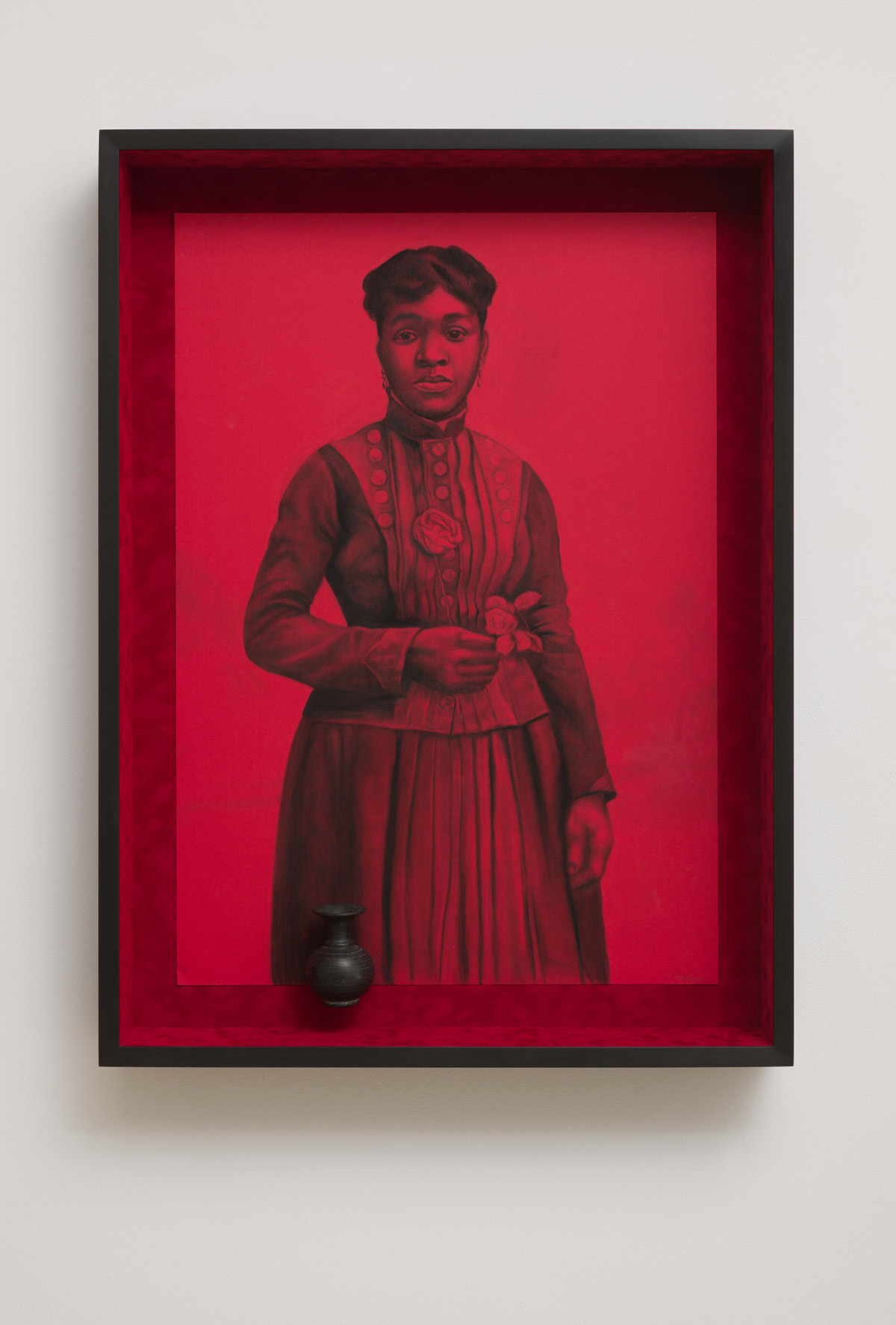 Black and white full-length portrait on a red ground of a Black woman in late-19th century dress.