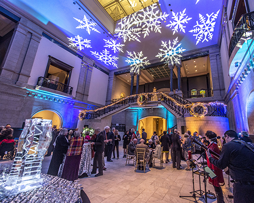 A fundraising event in the Great Hall, with a live band and colorful projections