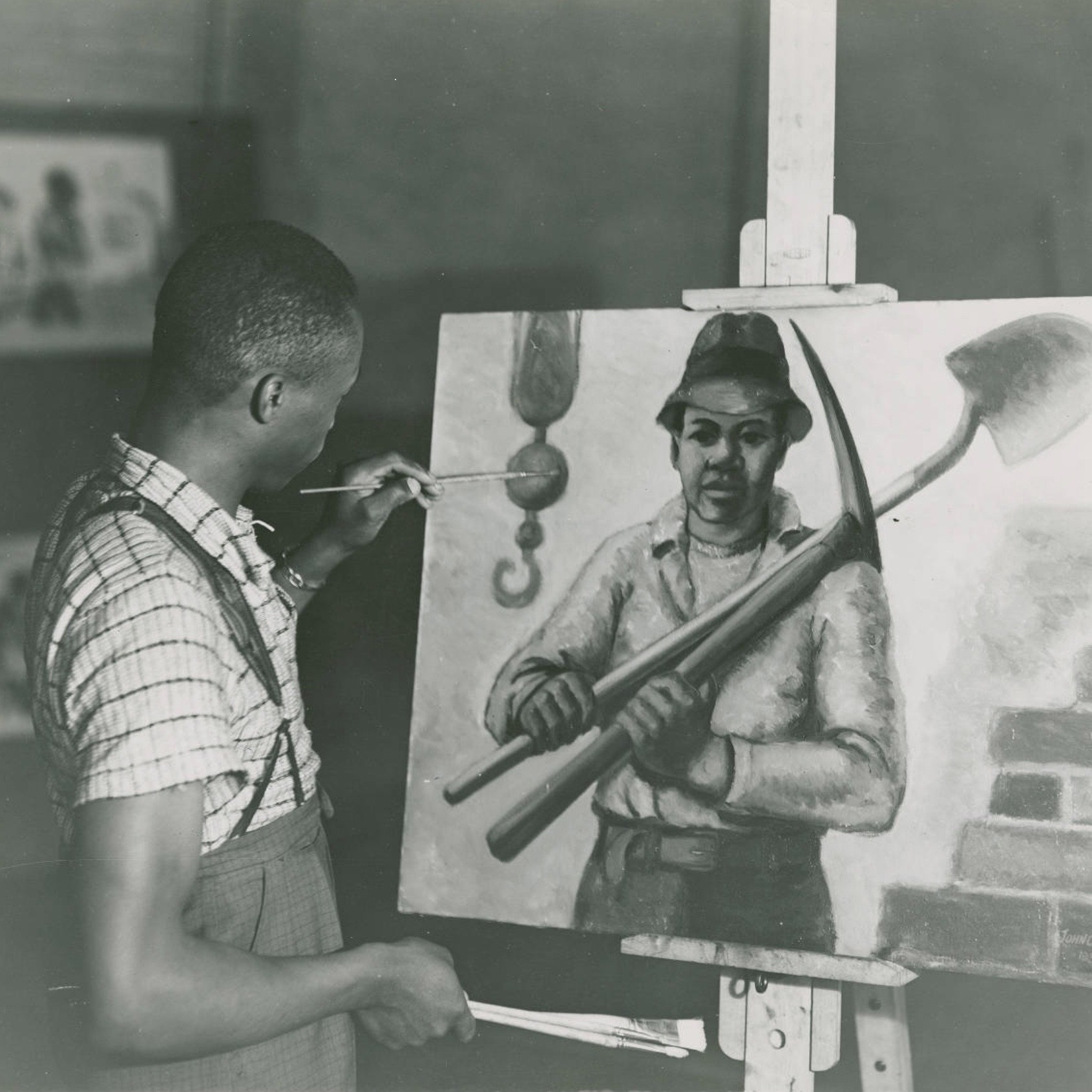 John C. Lutz putting the finishing touches to his painting