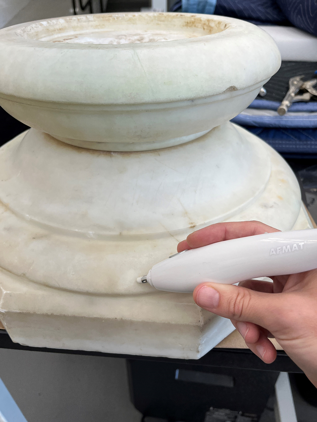 Using a tool to clean the marble base