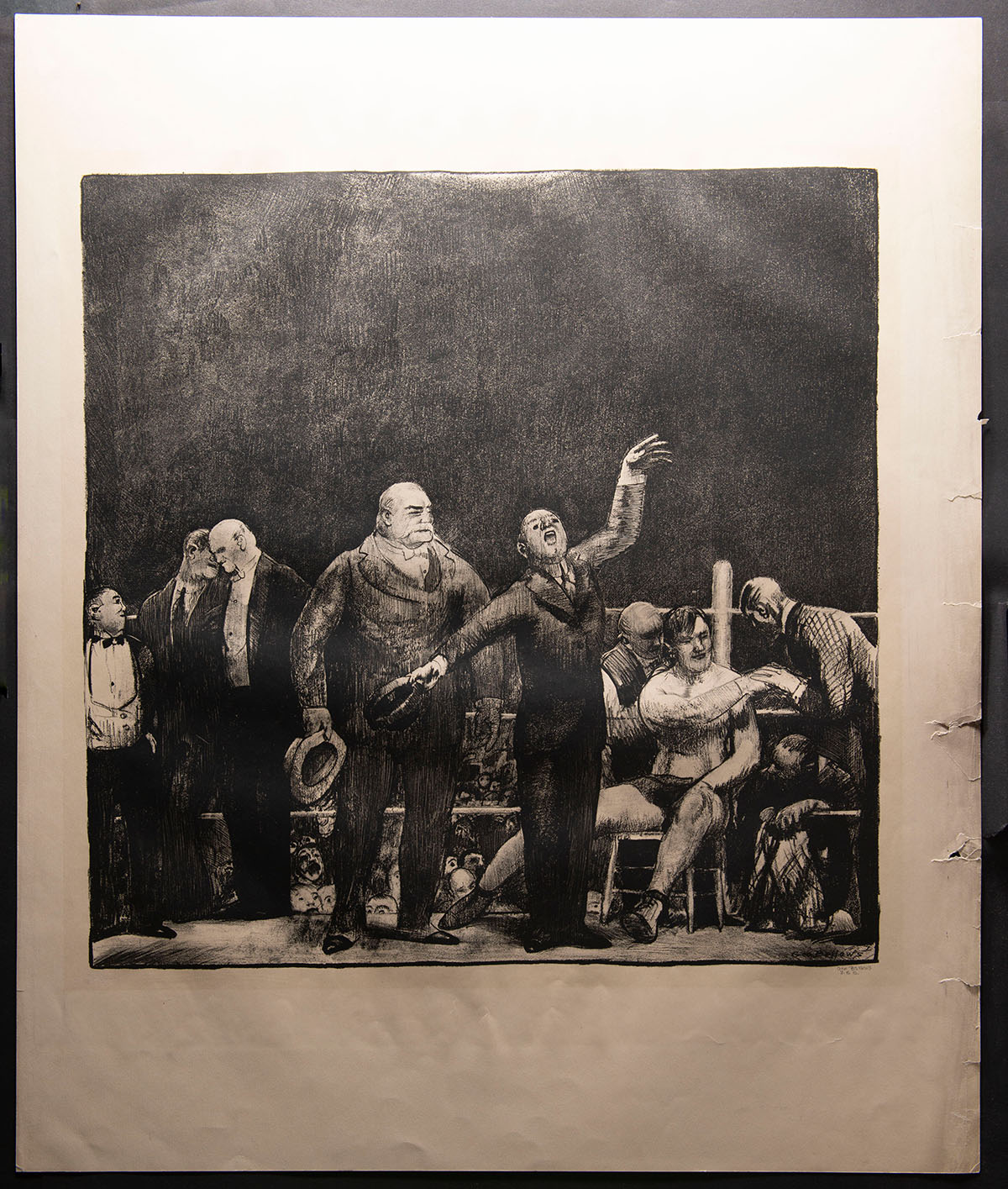 The print under an angled light, showing wrinkles and tears