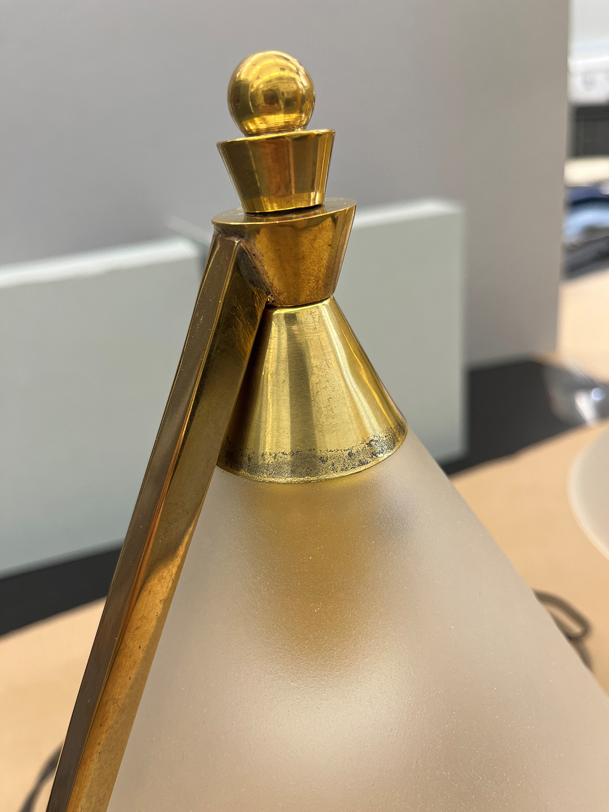 Closer detail of the black tarnish on the gold metal of the lamp