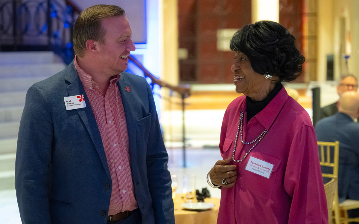 Brad laughs with a smiling Black Founder