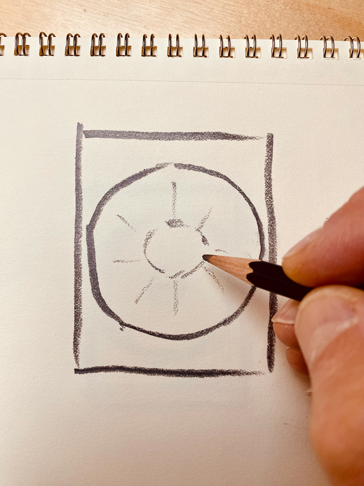 A rough pencil sketch of a circle in a rectangle